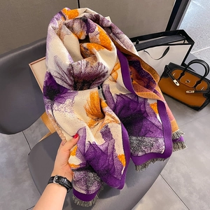 Thick cashmere-like scarf with large purple and orange floral patterns and tassels