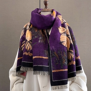 Thick warm purple cashmere-feel scarf with orange floral pattern and tassels on model