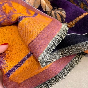 Thick autumn winter cashmere scarf in orange and purple with tassels and leaf patterns
