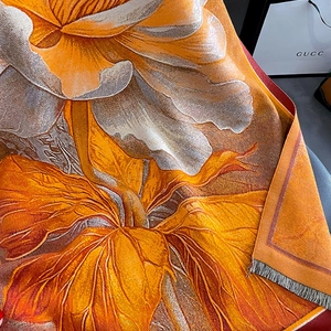 Detail of soft pashmina shawl with vibrant floral print and fine fringe trim edges