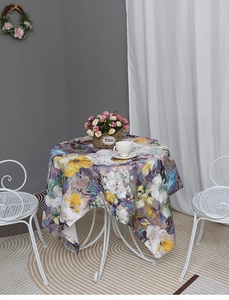 Detailed close-up of round tablecloth featuring colorful oil painting floral patterns