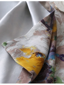 Detailed macro view of American impressionist floral oil painting pattern on satin tablecloth