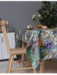 Detail of oil painting floral tablecloth with thick texture on wooden dining table