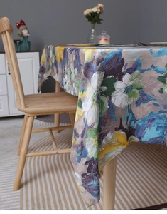 Close-up of Impressionist floral tablecloth with vibrant yellow and blue artistic patterns