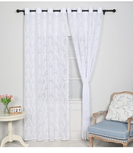 Close-up of white lace curtain with Damascus embroidery and metal grommet rings