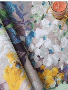 Close-up detail of textured Impressionist floral tablecloth with vibrant oil painting pattern