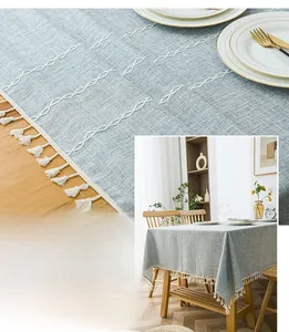 Close-up of Nordic striped tablecloth with white diamond weave and beige tassels