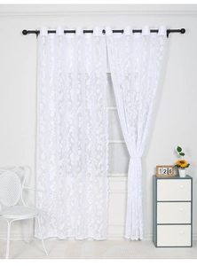 Close-up of white lace sheer curtain with delicate floral embroidery and grommet top detail