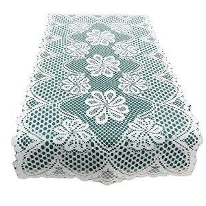 White lace placemat with hexagonal mesh and floral embroidery in Nordic minimalist style
