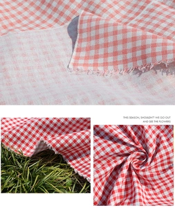 Macro view of bohemian plaid picnic mat fabric with red and pink checkered weave