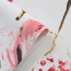 Close-up of Nordic style printed fabric showing pink floral patterns and woven texture