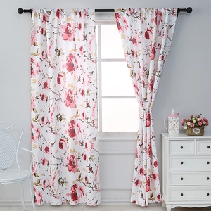 Detail of floral eyelet curtains featuring red roses and green leaves on white fabric