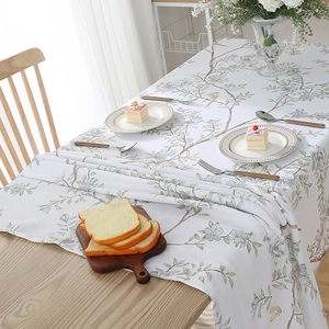 Detail of bird and floral pattern on a modern rectangular linen tablecloth for home decor