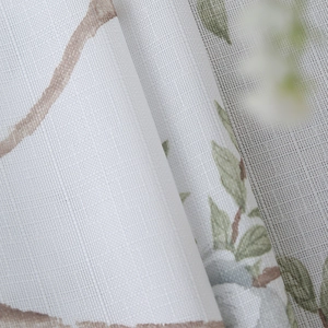 Close-up of bird branch pattern on linen-textured rectangular tablecloth fabric