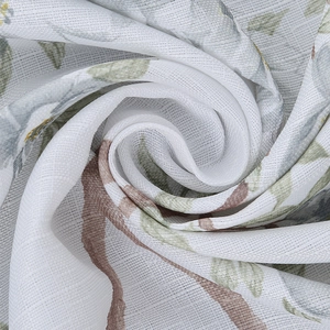 Detail of Nordic table cloth fabric with green leaves and bird print pattern