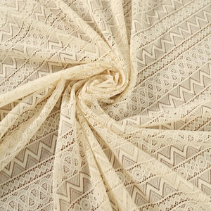 Beige crochet lace tablecloth with hollow geometric patterns in a bohemian style