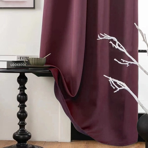 Detail of burgundy blackout curtain fabric with elegant matte satin texture and heavy drape