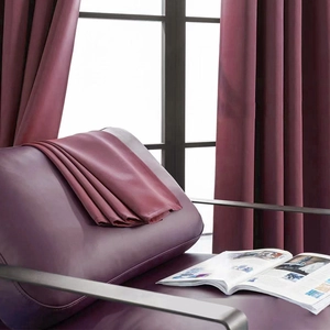 Close-up of luxury burgundy blackout curtain fabric with silky texture and elegant drape