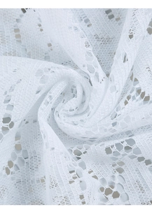 Close-up of white lace placemat featuring intricate floral mesh patterns and soft textures