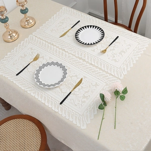 Pair of modern beige lace placemats with hollowed weave and elegant scalloped edges