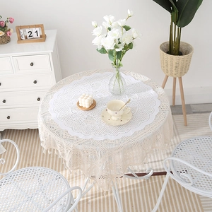 Modern minimalist round lace placemat with layered crochet design and tassel edges