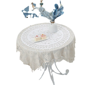 Modern white round lace placemat with hollow geometric patterns and handmade tassels