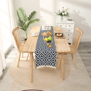 Moroccan blue geometric table runner with tassels on light wood dining table