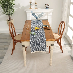 Modern Nordic blue chenille table runner with white geometric leaf patterns and tassels