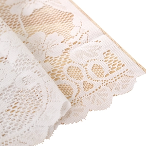 Modern white lace cafe curtain with floral embroidery on natural wood background