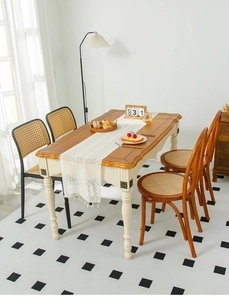 Close-up of vintage American style wooden dining table with ornate carved floral details