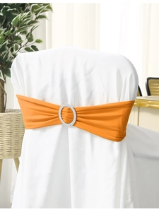 Detail of orange elastic chair sash with a silver sparkly rhinestone buckle for weddings