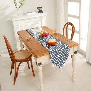 Modern minimalist table runner with blue Moroccan geometric patterns and white tassels