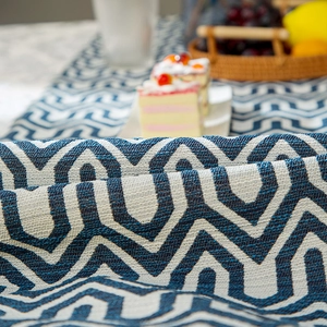 Blue and white woven table runner with modern geometric patterns for home decor