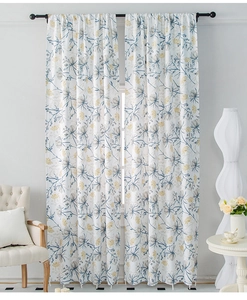 Detail of floral linen curtains with blue and gold flower patterns in a bright living room