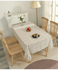 Detailed texture of blue and cream striped linen tablecloth on a rectangle dining table