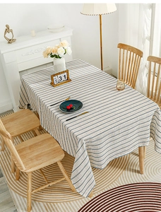 Detail of linen texture and blue stripes on cream tablecloth in a home setting