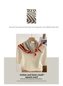 Detail of geometric cotton linen scarf with orange border tied on a white knit top