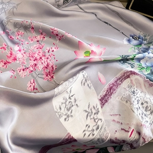 Close-up of silk scarf showing pink cherry blossoms and traditional vase patterns