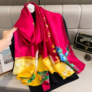 Elegant silk-like floral scarf shawl in vibrant pink and yellow with floral patterns