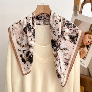 Women's autumn floral square silk scarf with brown trim paired with a cream knit sweater