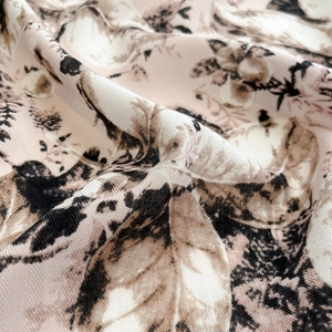 Macro detail of soft pink twill fabric with vintage leaf patterns and smooth texture