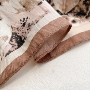 Macro view of twill silk scarf showing fine stitching and classic hound print detail