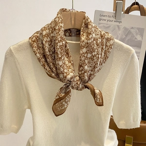Elegant floral square scarf in brown and white styled with cream knit sweater