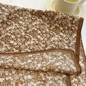 Detailed close-up of retro floral pattern scarf with berries and premium hemmed edges