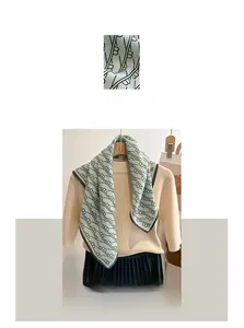 Detailed macro texture of light green linen cotton scarf with elegant letter patterns