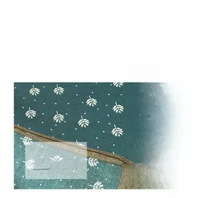 Detailed close-up of premium cotton linen fabric texture and elegant leaf print patterns
