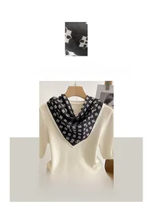 Detail of cotton linen square scarf with black and white geometric pattern on white top