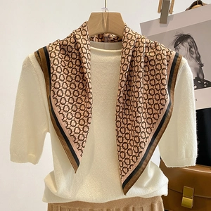 Elegant khaki square neck scarf with vintage black chain print styled on a white top