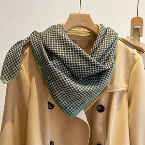 Classic houndstooth square scarf in grey-green and black on a trench coat