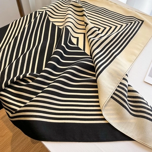 Detail of elegant black and beige striped satin scarf with a smooth diagonal texture